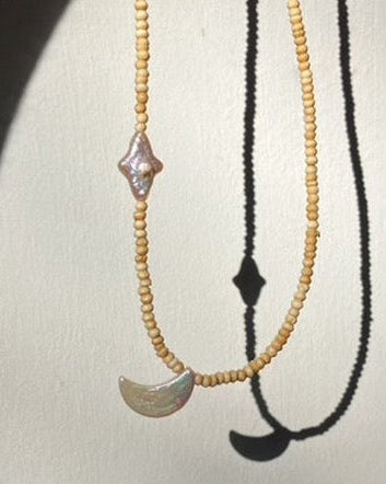 Two beaded necklaces with decorative pendants on a white background