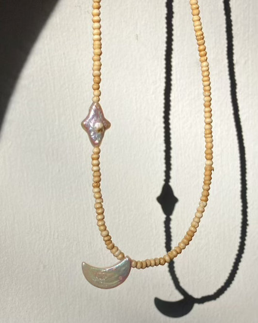 Necklace with natural stone pendants on a plain background